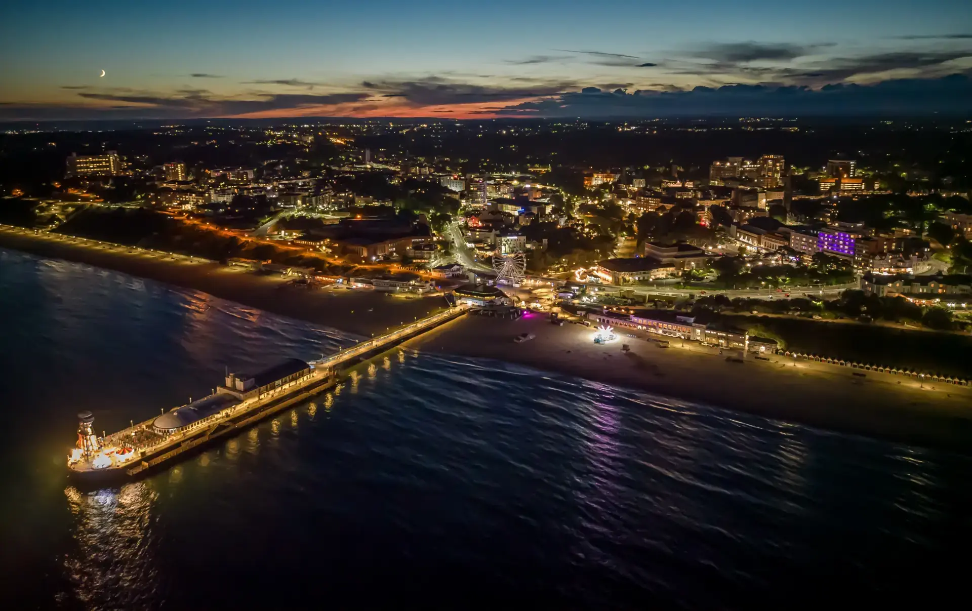 Bournemouth Pier and promenade lit up at night